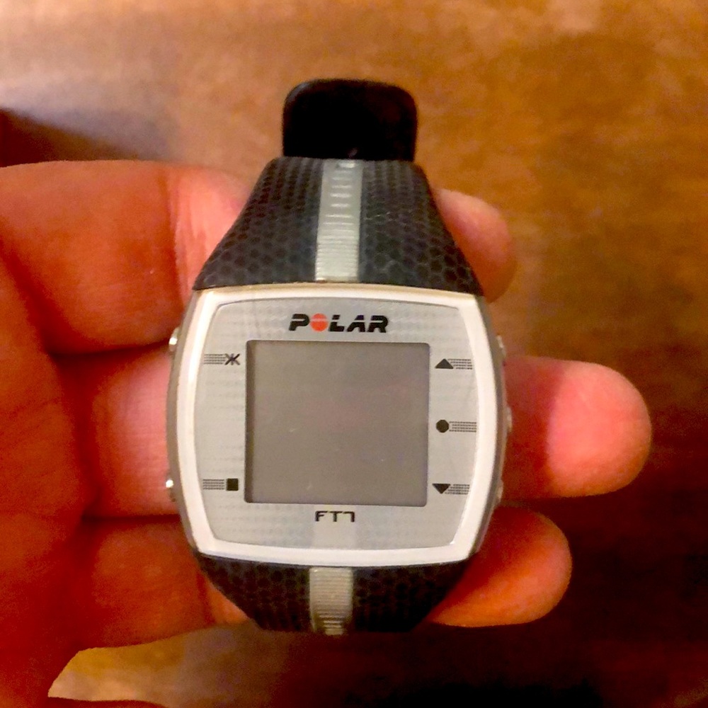 Polar watch with heart rate chest strap monitor.